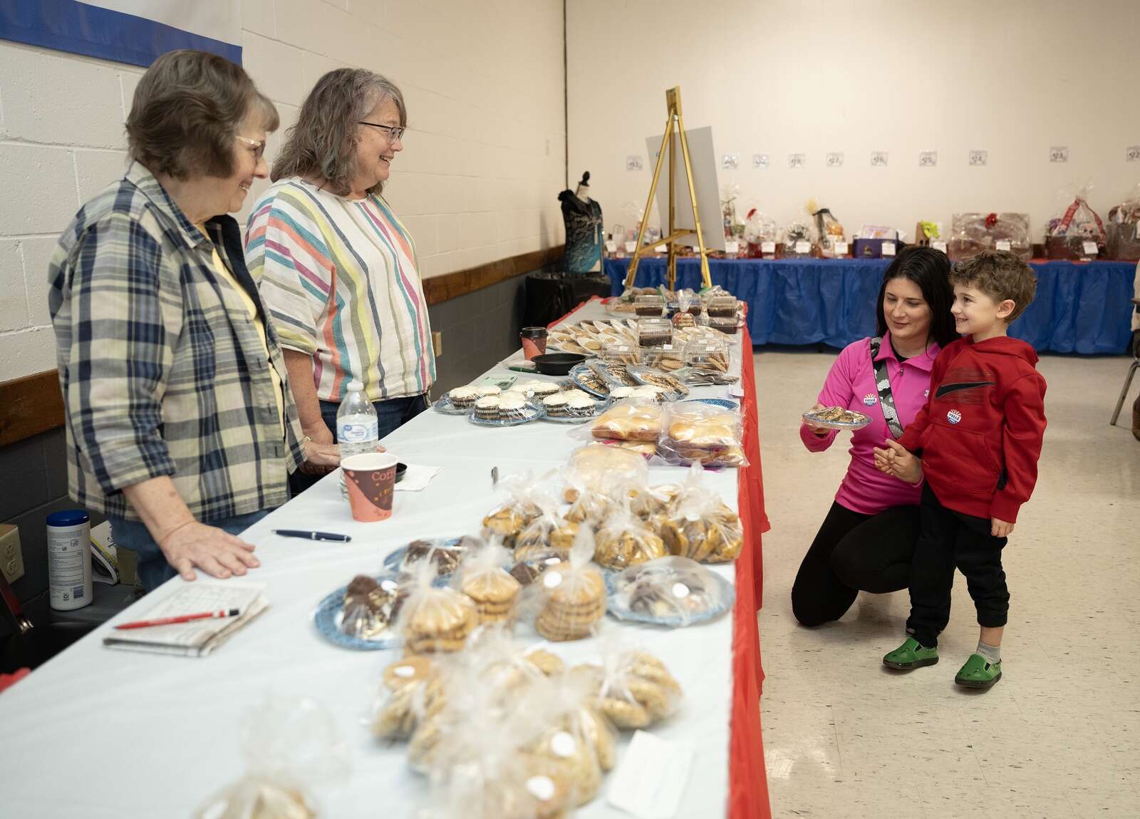 Karen Grosclaude and Marci Shay hand out cookies