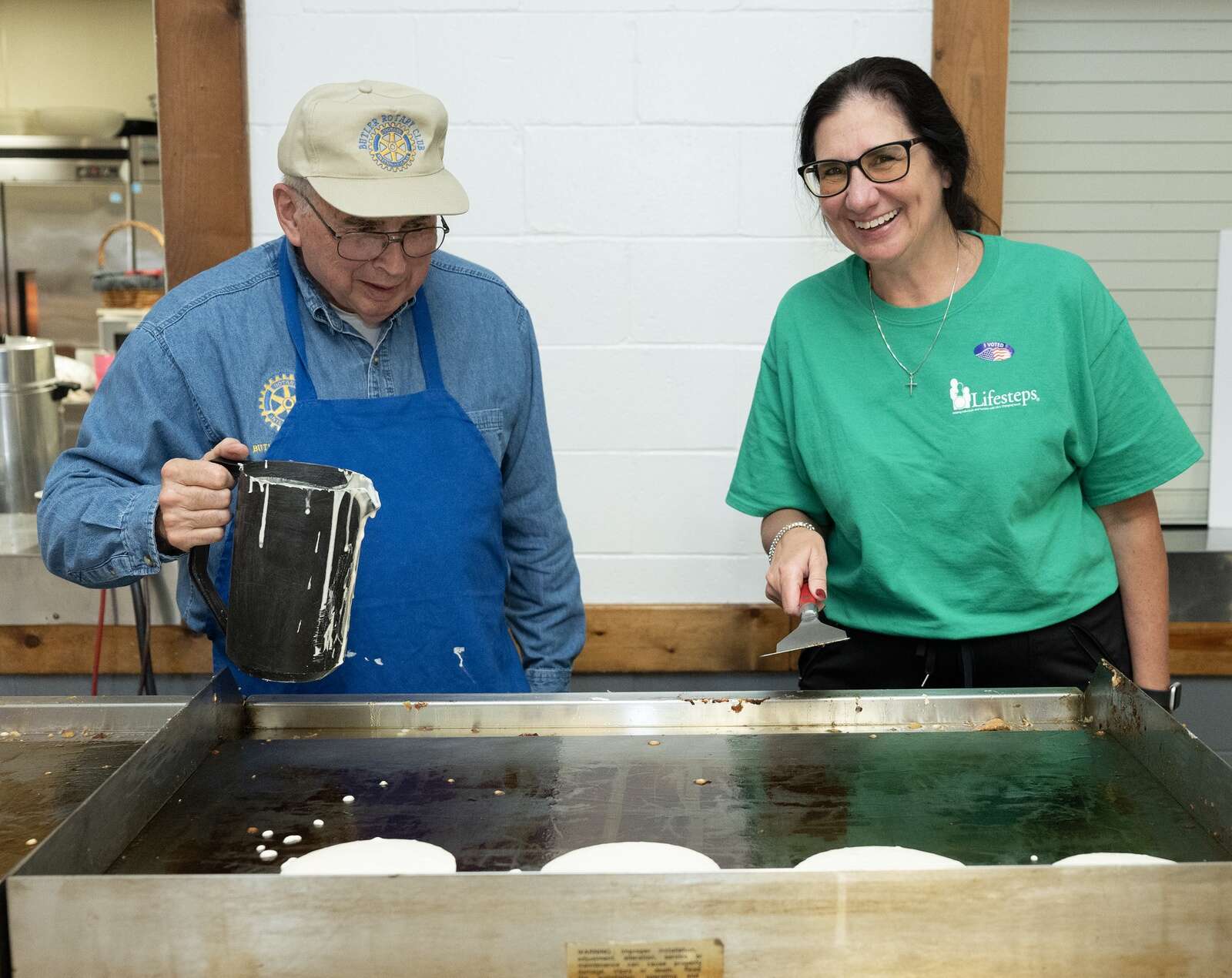 Karen Sue Owens, right, president and CEO of Lifesteps, cooks more pancakes