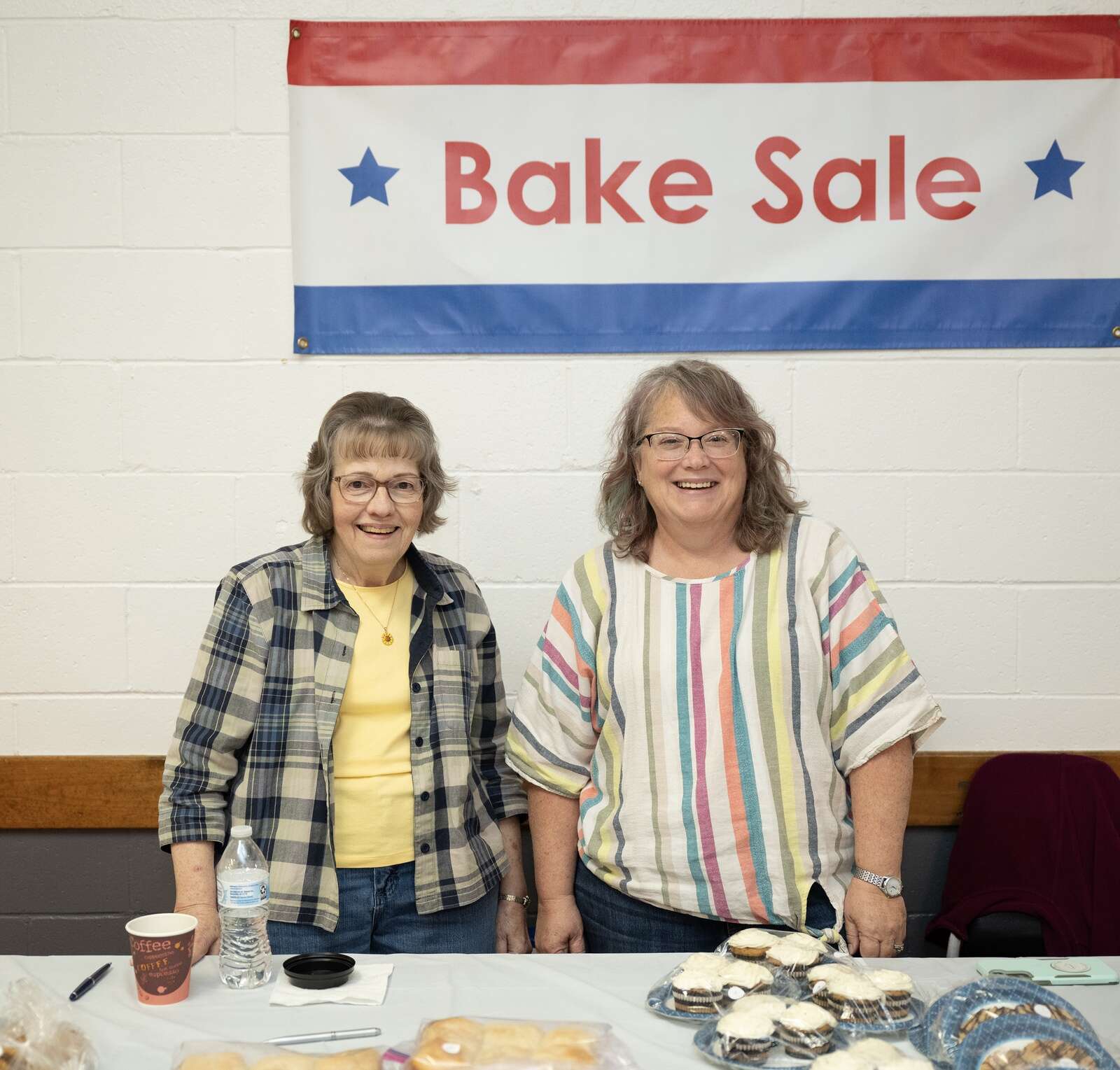 Karen Grosclaude and Marci Shay tend the baking table