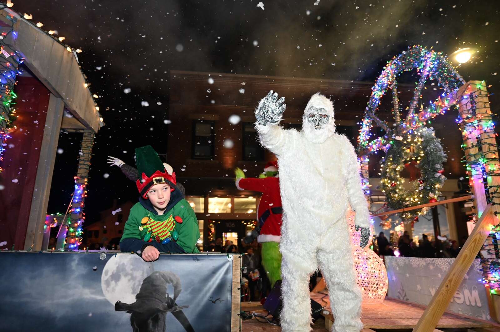 The abominable snowman waves from a float uring the Miracle on Main parade