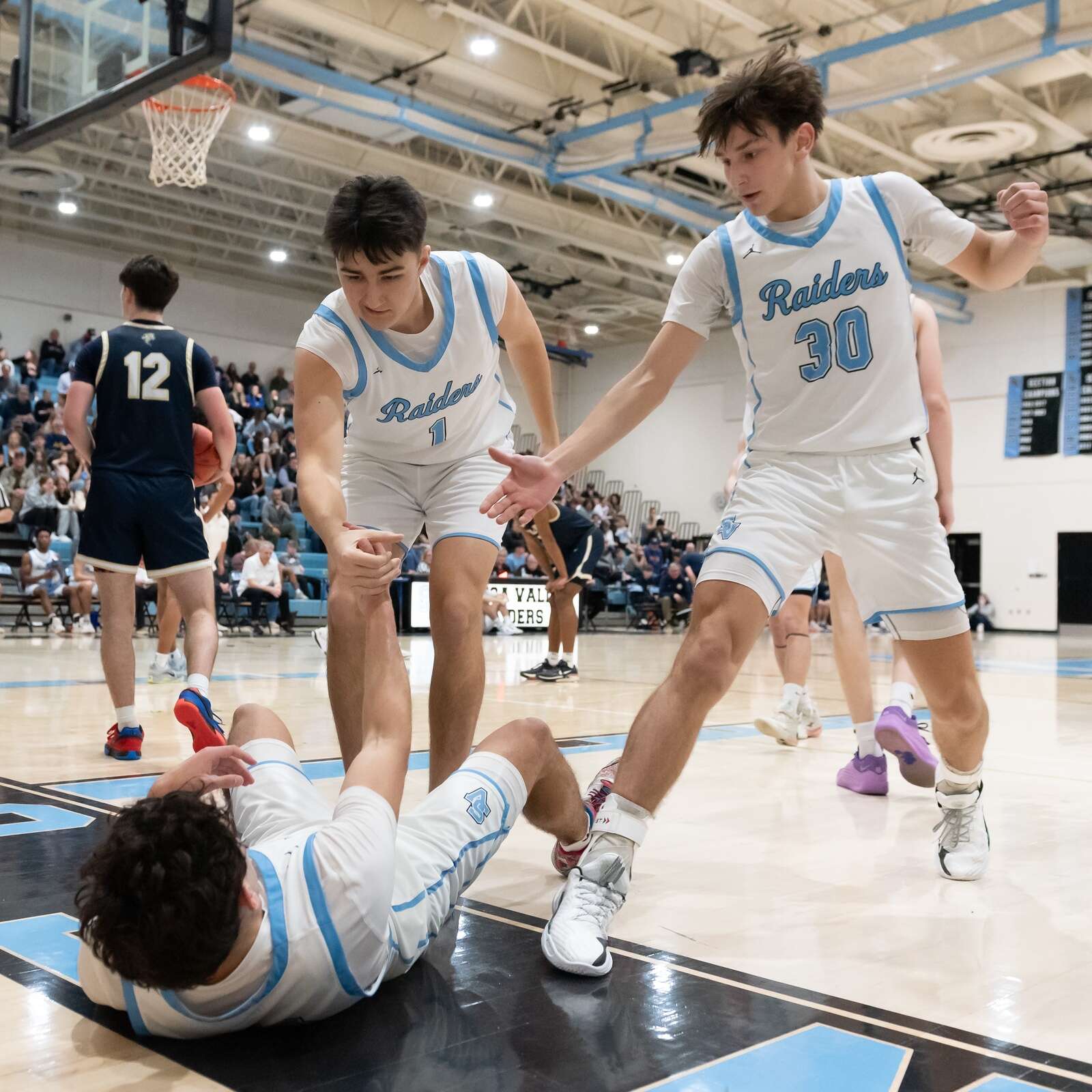 Seneca Valley’s Tyler Pepin is helped to his feet by teammates