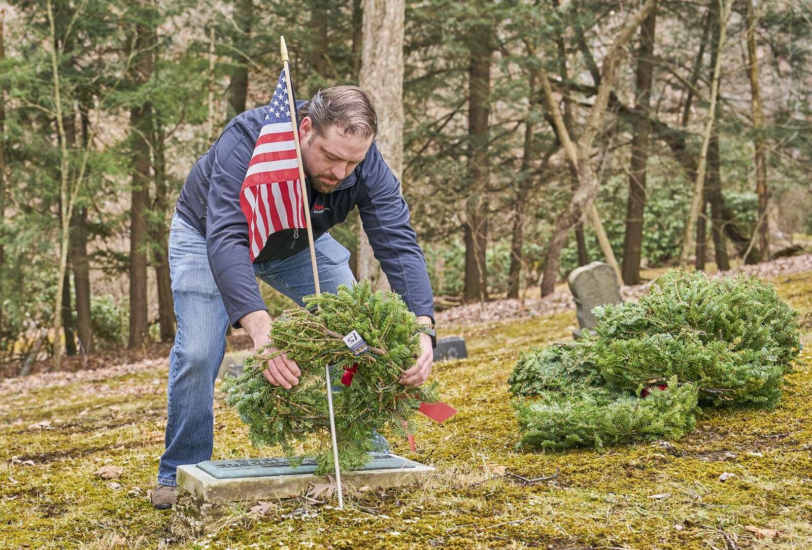 David Rolley places a wreath at the gravesite of a U.S. veteran