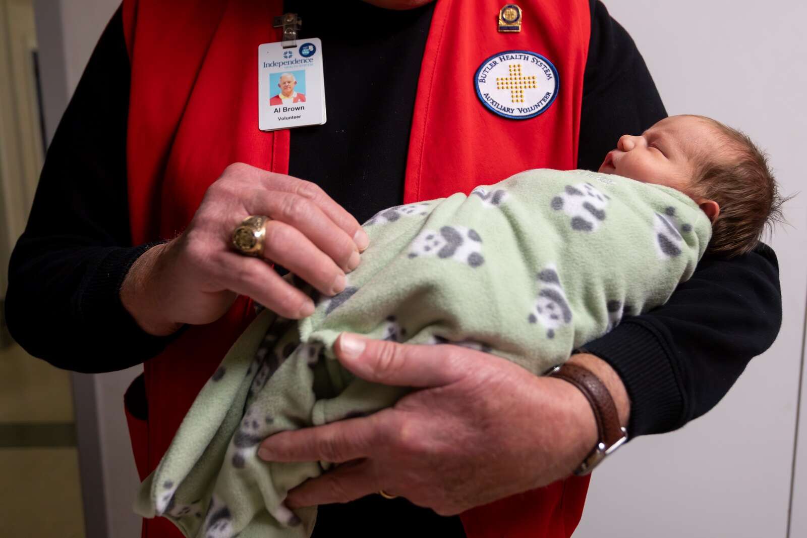 Butler Memorial Hospital Auxiliary volunteer Al Brown holds newborn Blaikley Keith