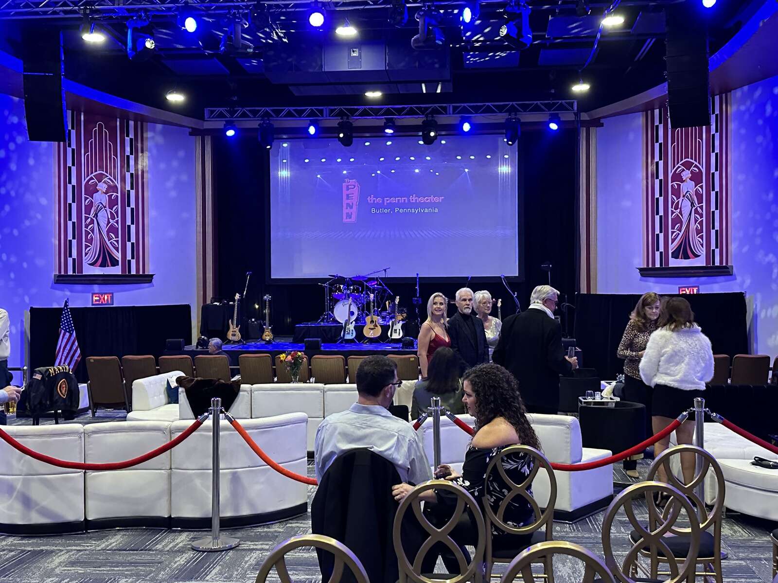 Attendees mingle at a private event celebrating the revitalization of the Penn Theater