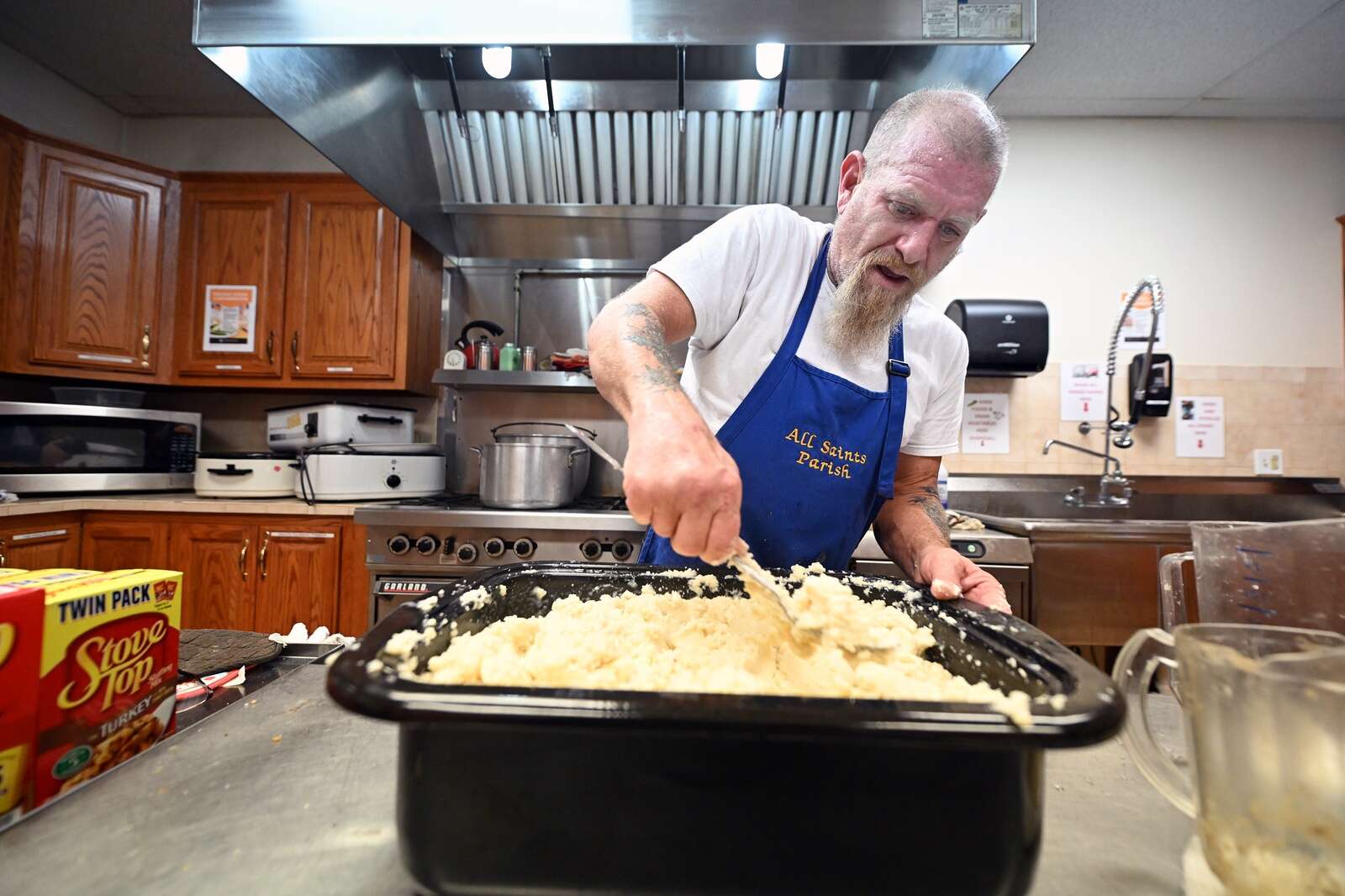 Volunteer preps food at the Thanksgiving Community Meal at St. Peter Roman Catholic Church