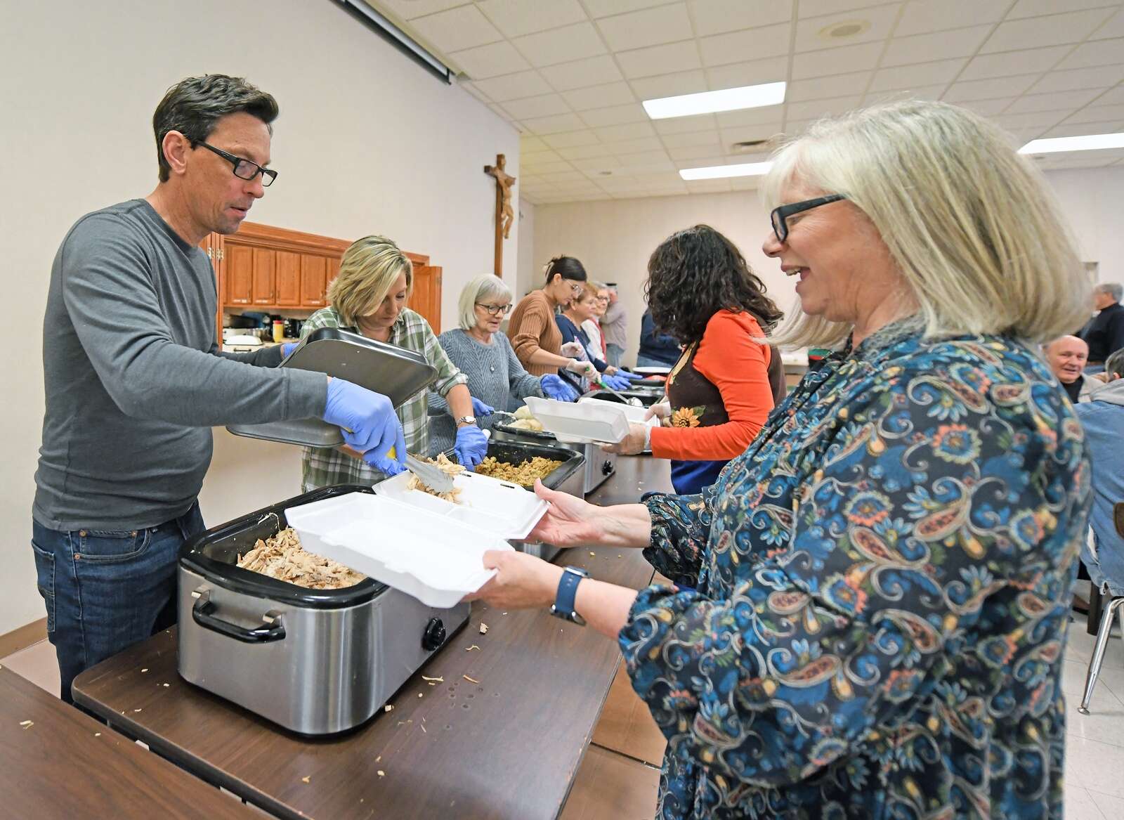 Volunteers serve food at the Thanksgiving Community Meal at St. Peter Roman Catholic Church