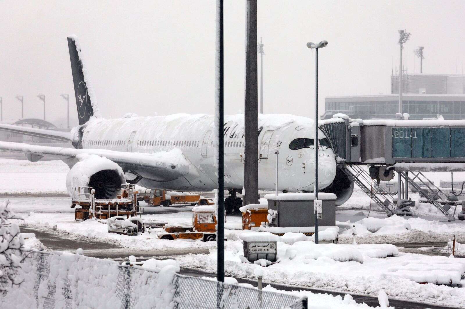 A Lufthansa aircraft parked at the snow-covered Munich airport in Germany