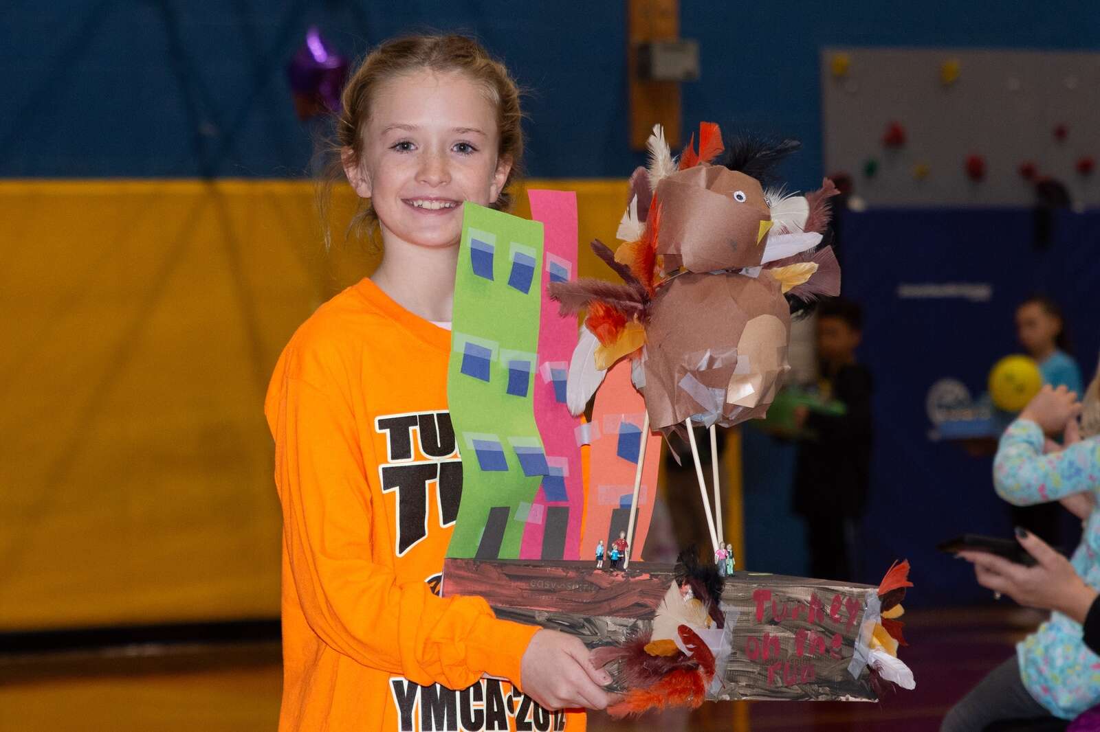 Student at Knoch Primary School holds up her handcrafted float