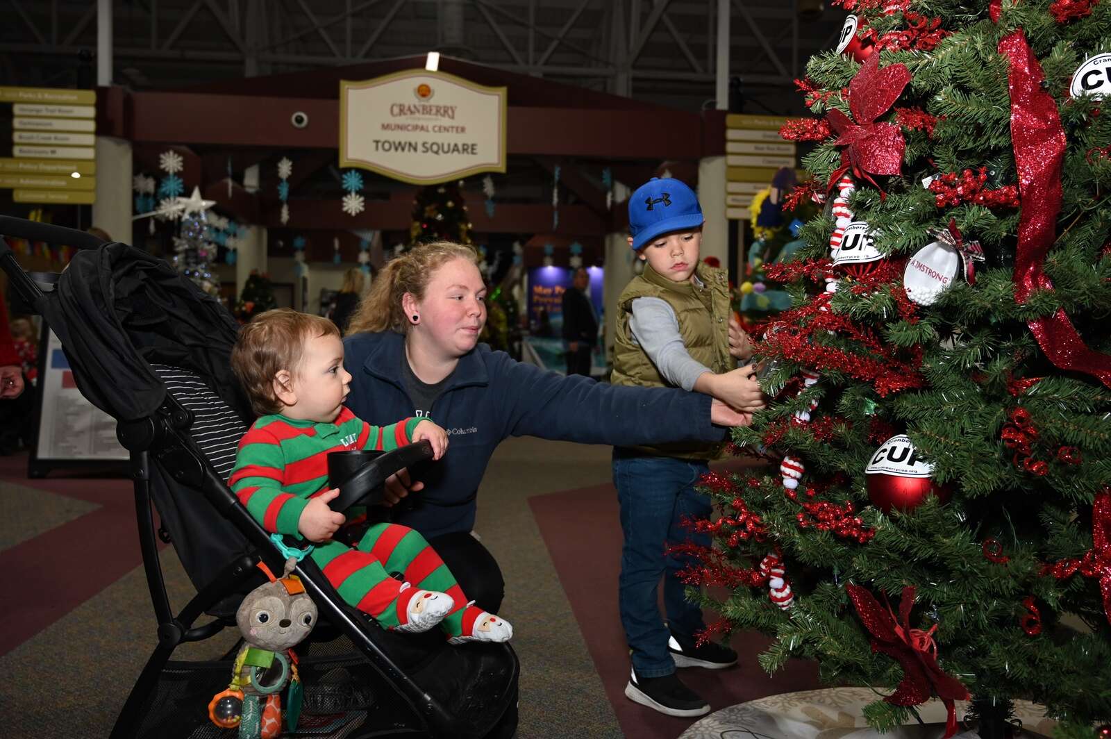 Emily Carson with her sons admire the many Christmas trees