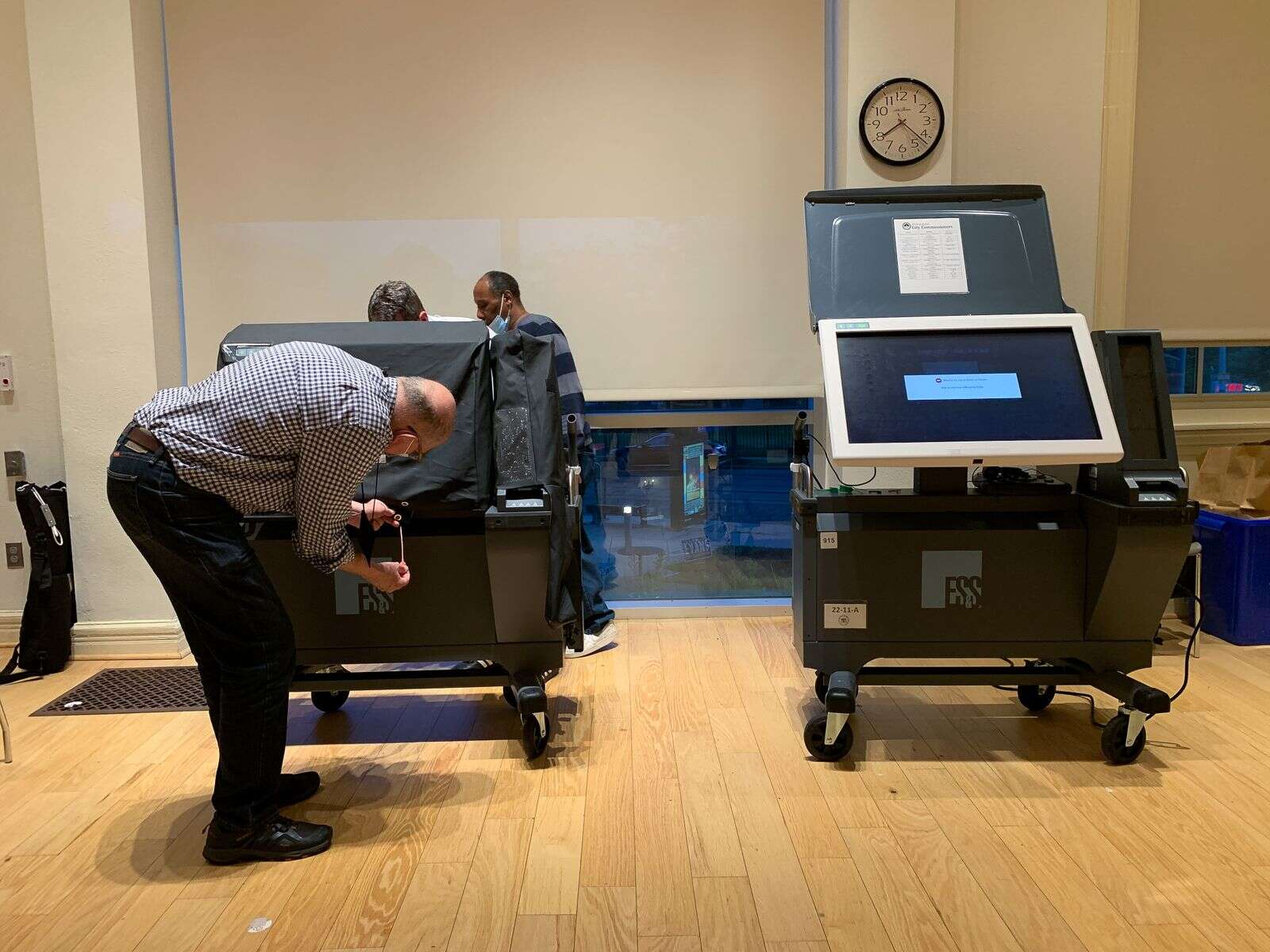 An election worker in Philadelphia, Pennsylvania examines an ExpressVoteXL voting machine during the 2022 primary. Sue Dorfman/For Votebeat