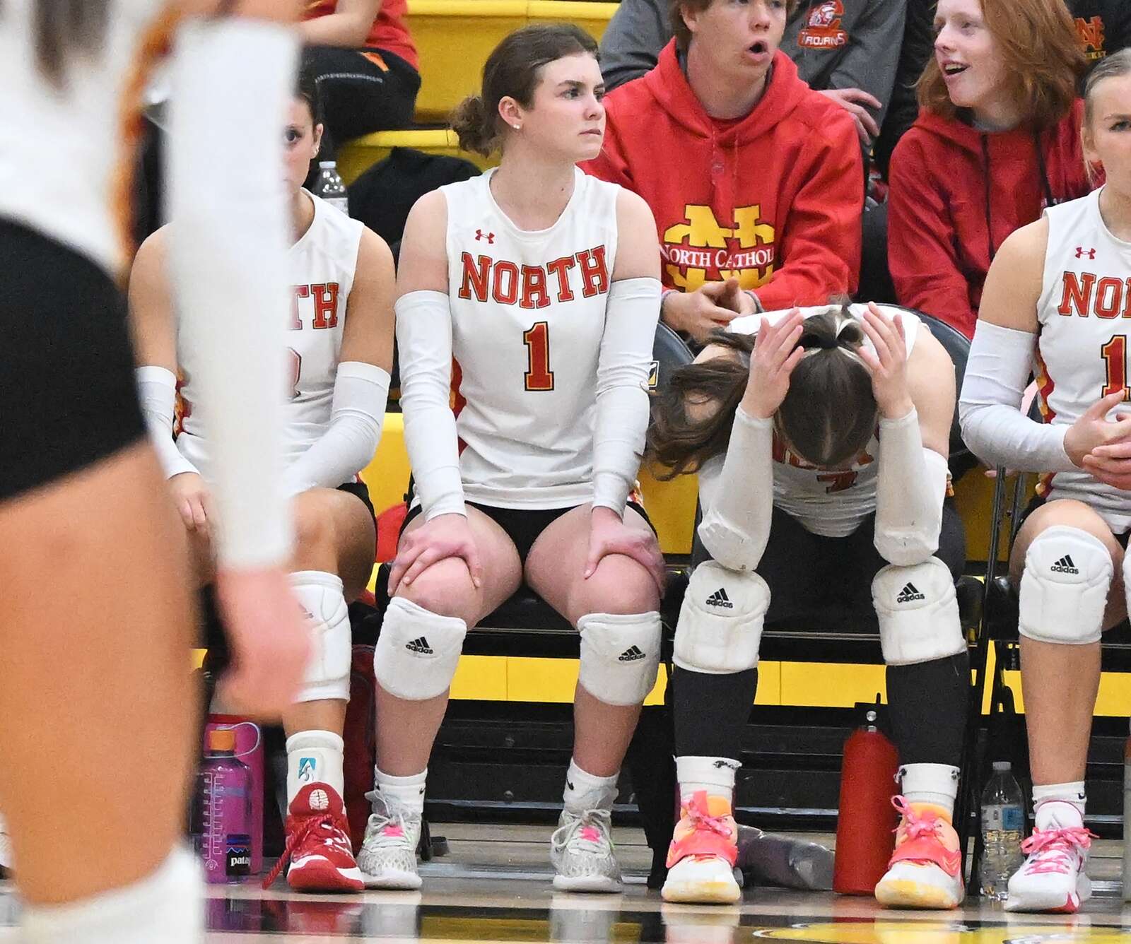 The North Catholic bench reacts after losing