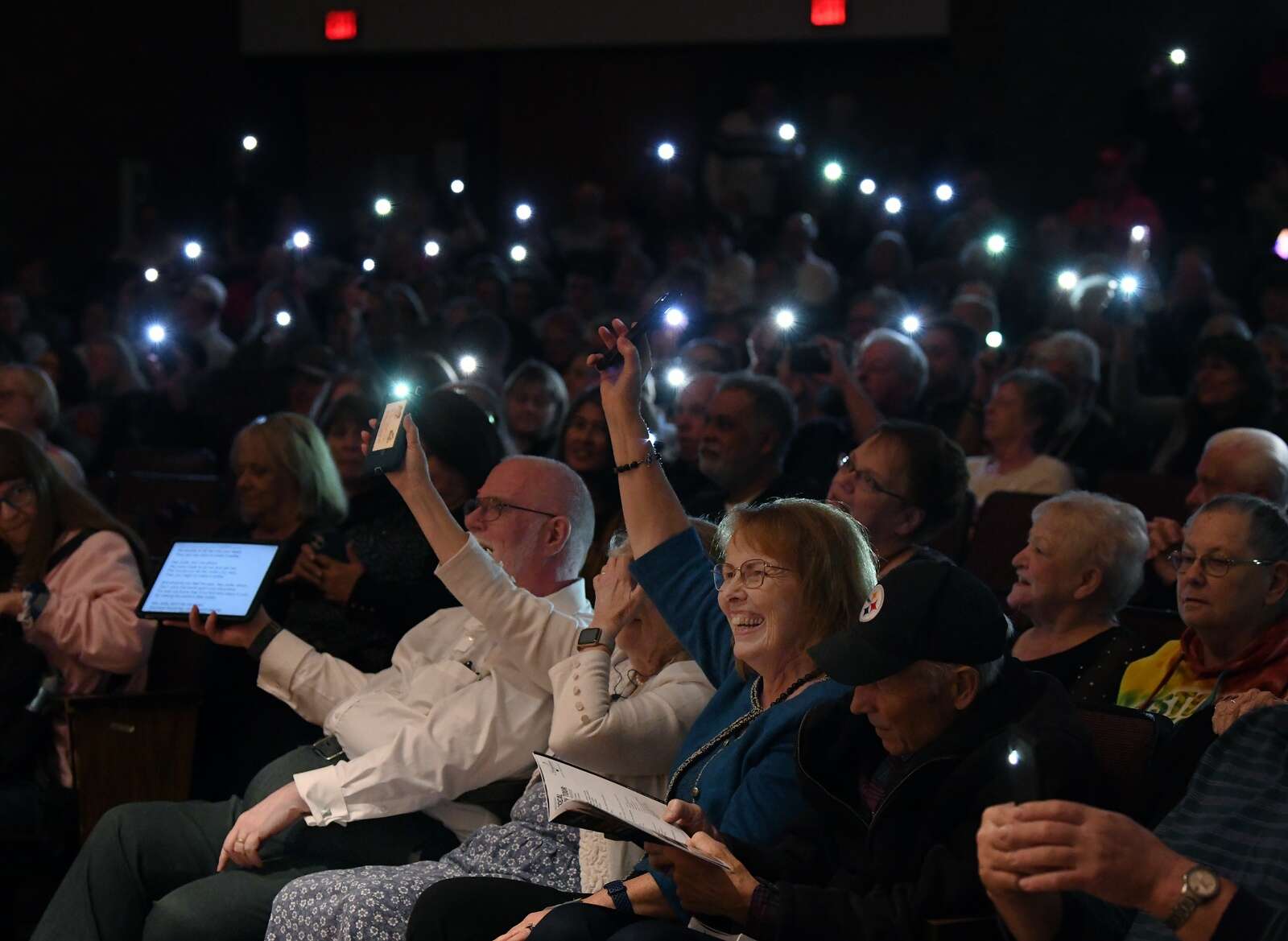 Ila Lombardo of Butler holds up her flashlight on her phone at “Classical Mystery Tour: a Tribute to the Beatles”