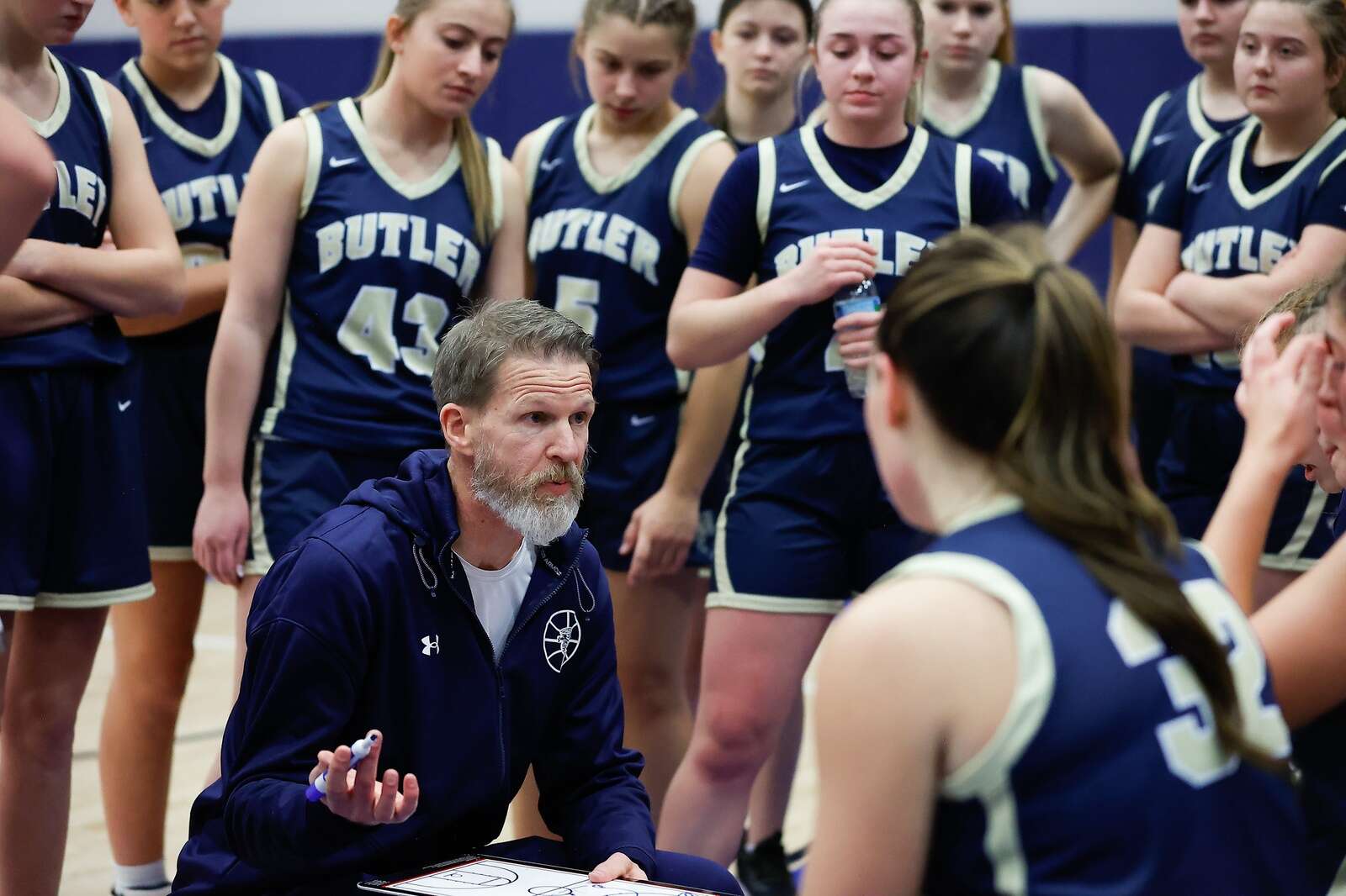 Butler head coach Mark Maier talks to the Golden Tornado’s girls basketball team