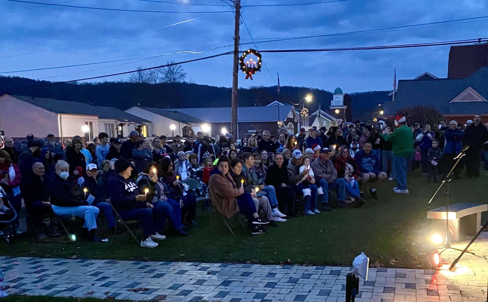 A large crowd awaits the tree lighting and holiday singers at East Brady’s We Believe Light-Up Night