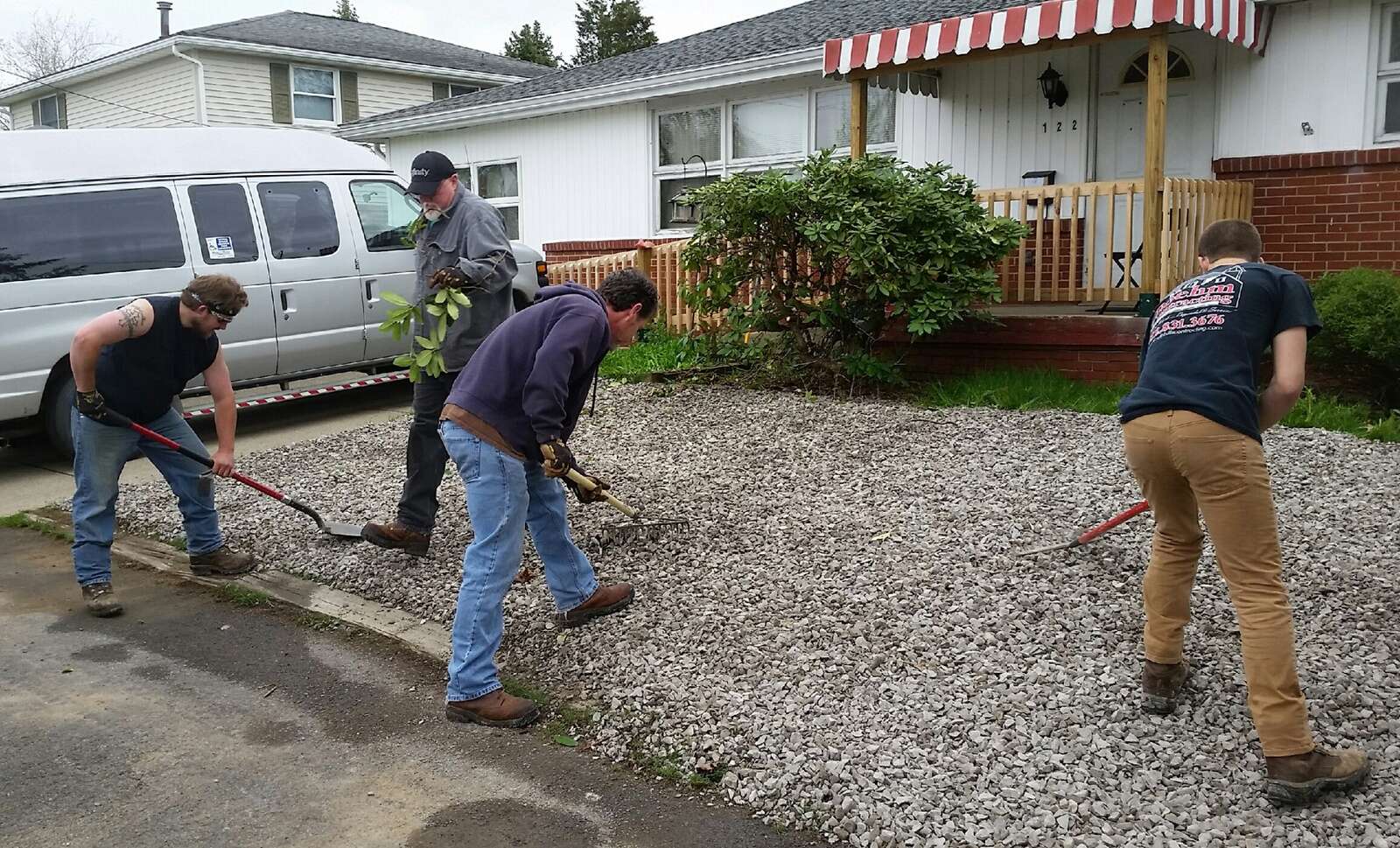 Volunteers work to beautify a community group home