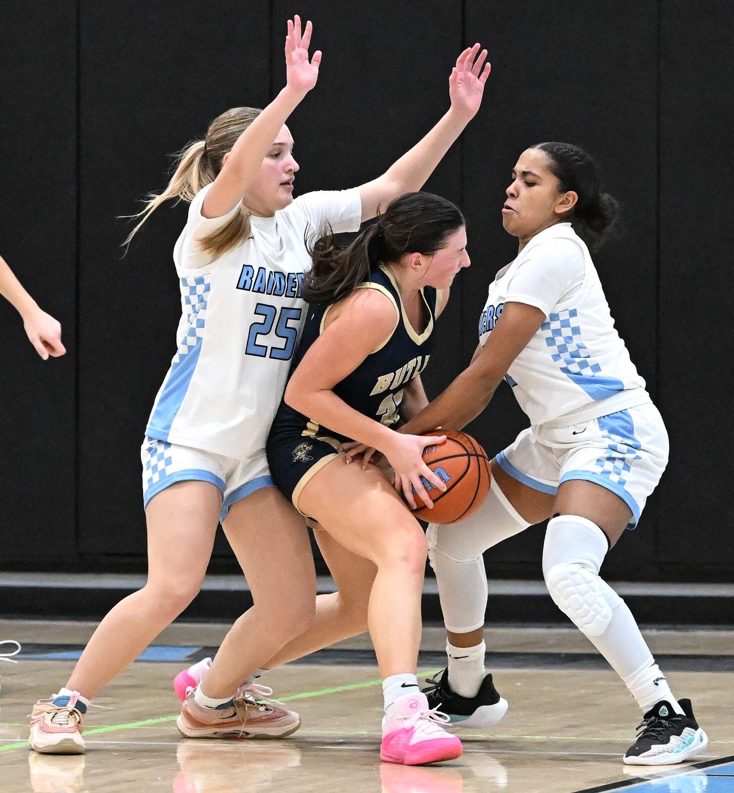 Seneca Valley’s Brooke Dufford and Makayla Canty fight for a ball against Butler’s Amelia McMichael