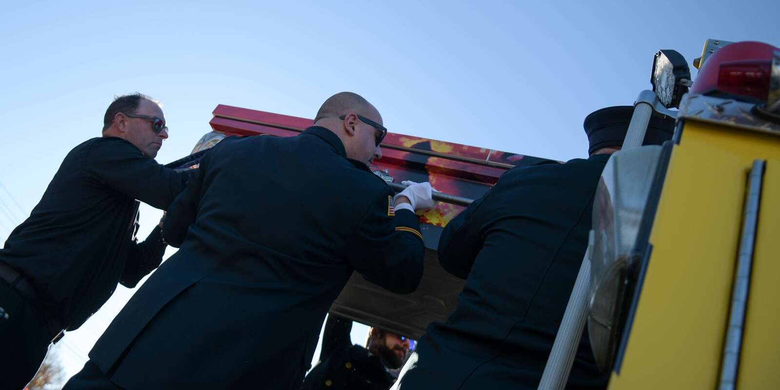 Pallbearers load Ken Wilson's casket onto Prospect Volunteer Fire Department Engine No. 13