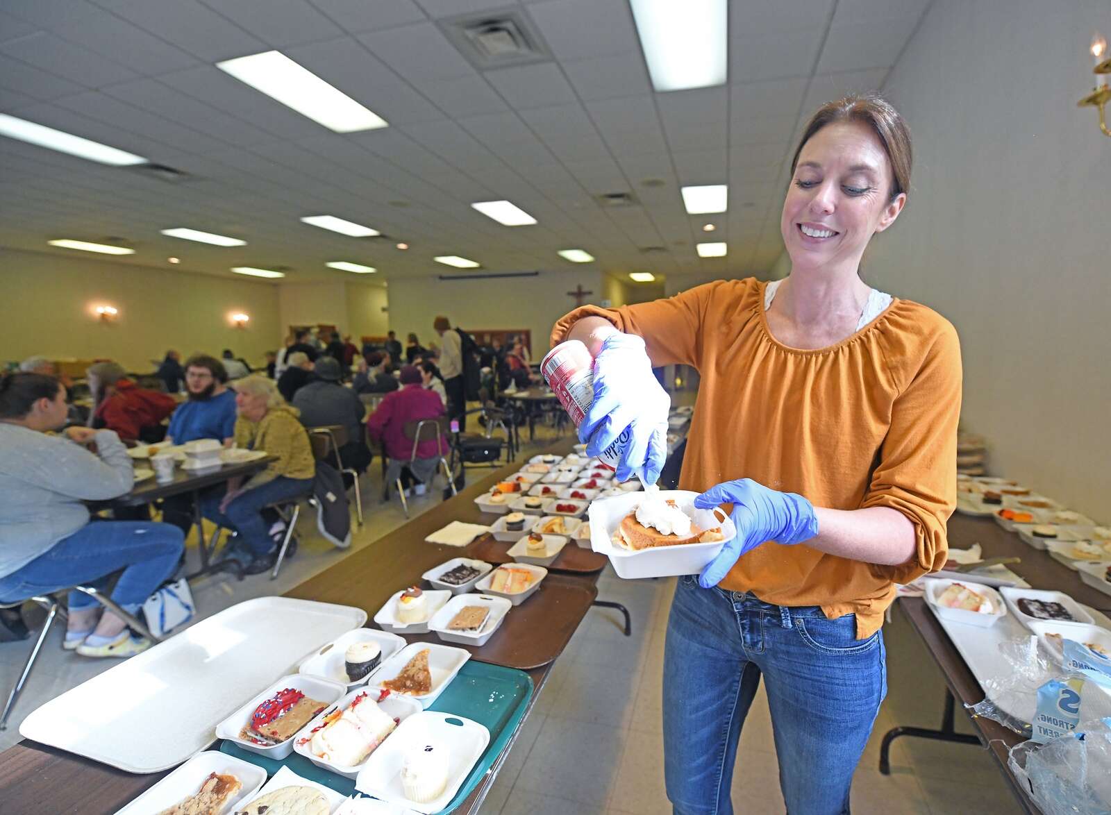 Volunteers serve food at the Thanksgiving Community Meal at St. Peter Roman Catholic Church