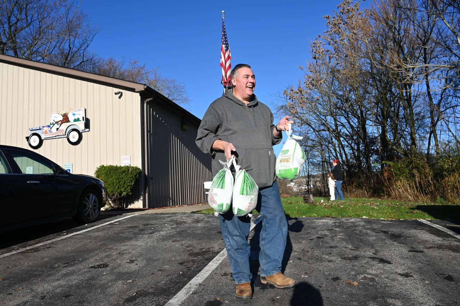 Brian Lippert of Penn Township carries donated turkeys to a car