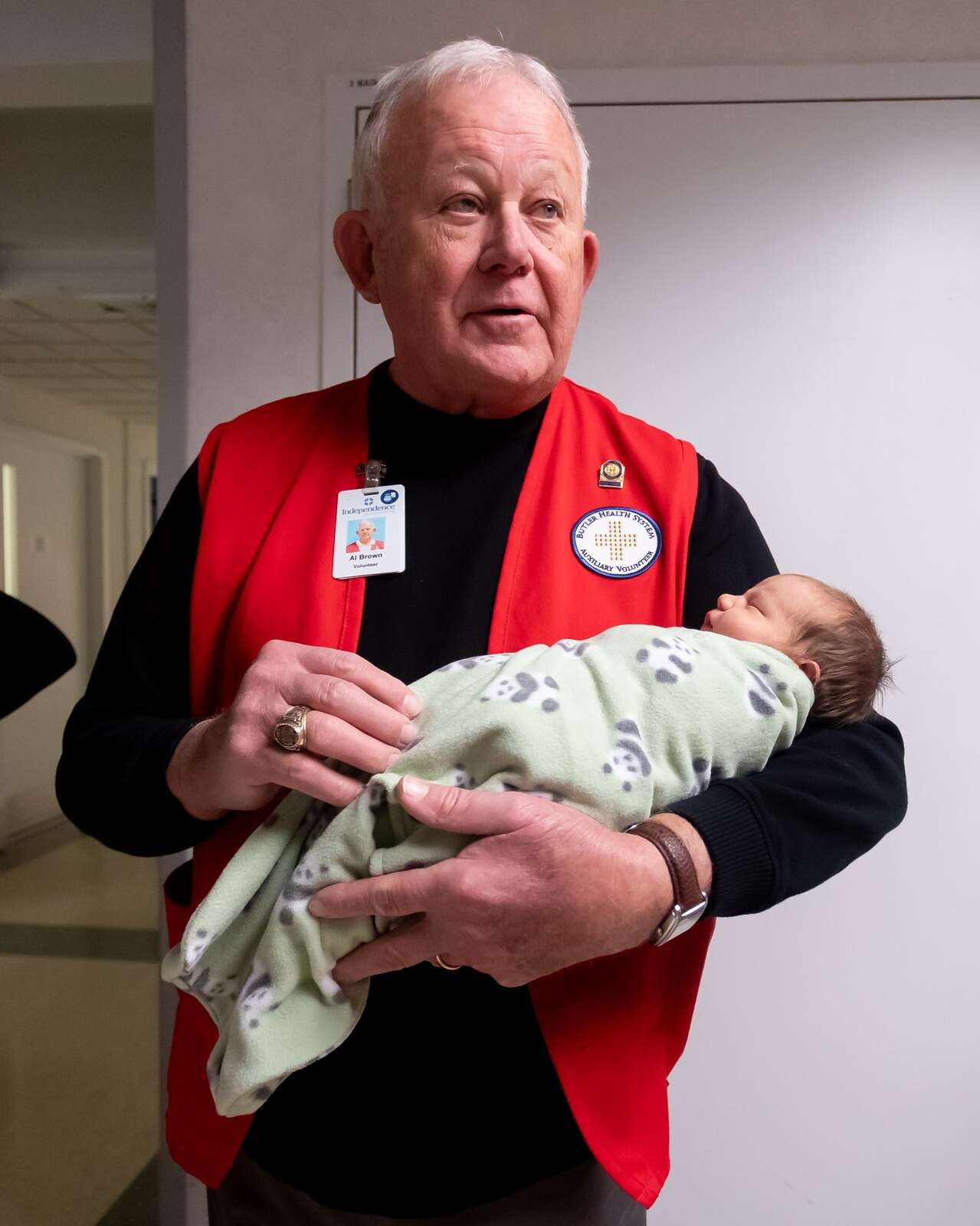 Butler Memorial Hospital Auxiliary volunteer Al Brown holds newborn Blaikley Keith