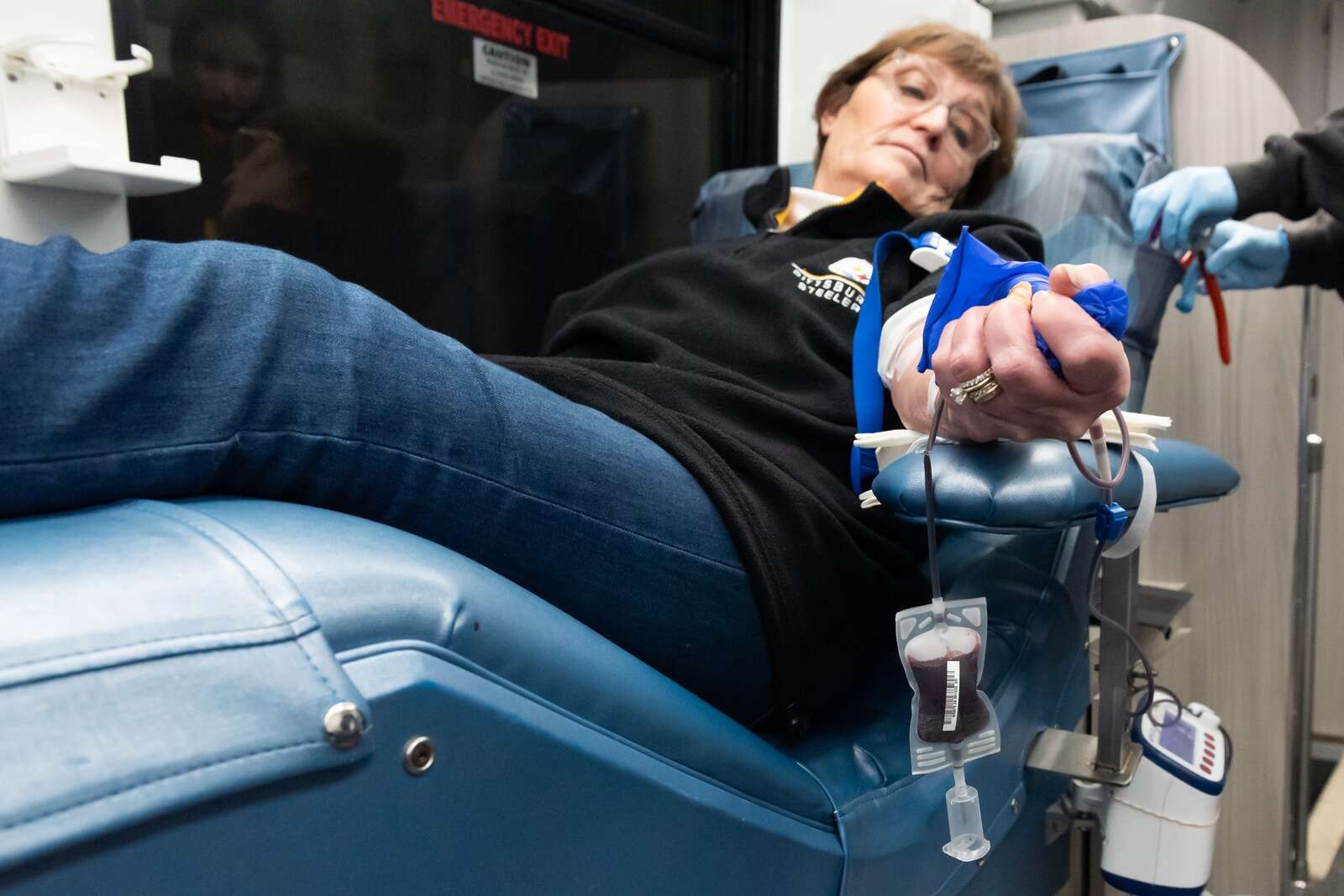Laura Warmbrod squeezes a stress ball while donating blood