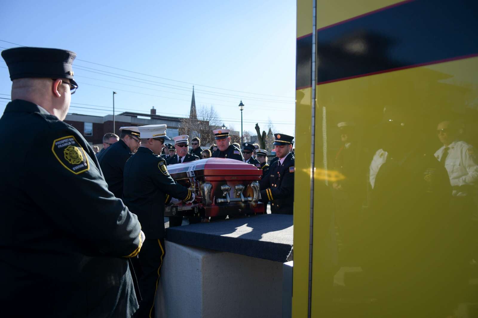 Pallbearers load Ken Wilson's casket onto Prospect Volunteer Fire Department Engine No. 13